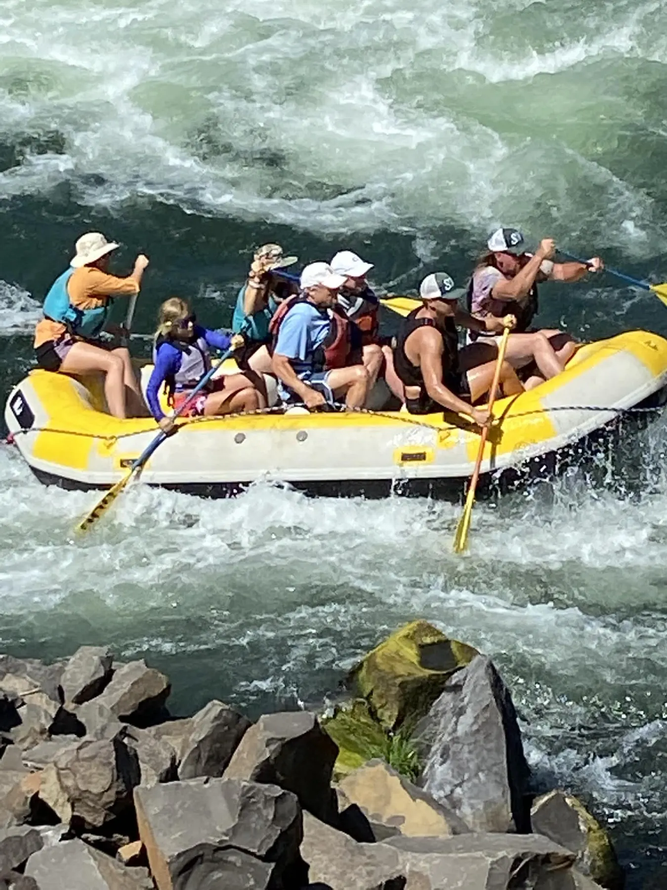A raft full of paddlers in whitewater on the Deschutes River